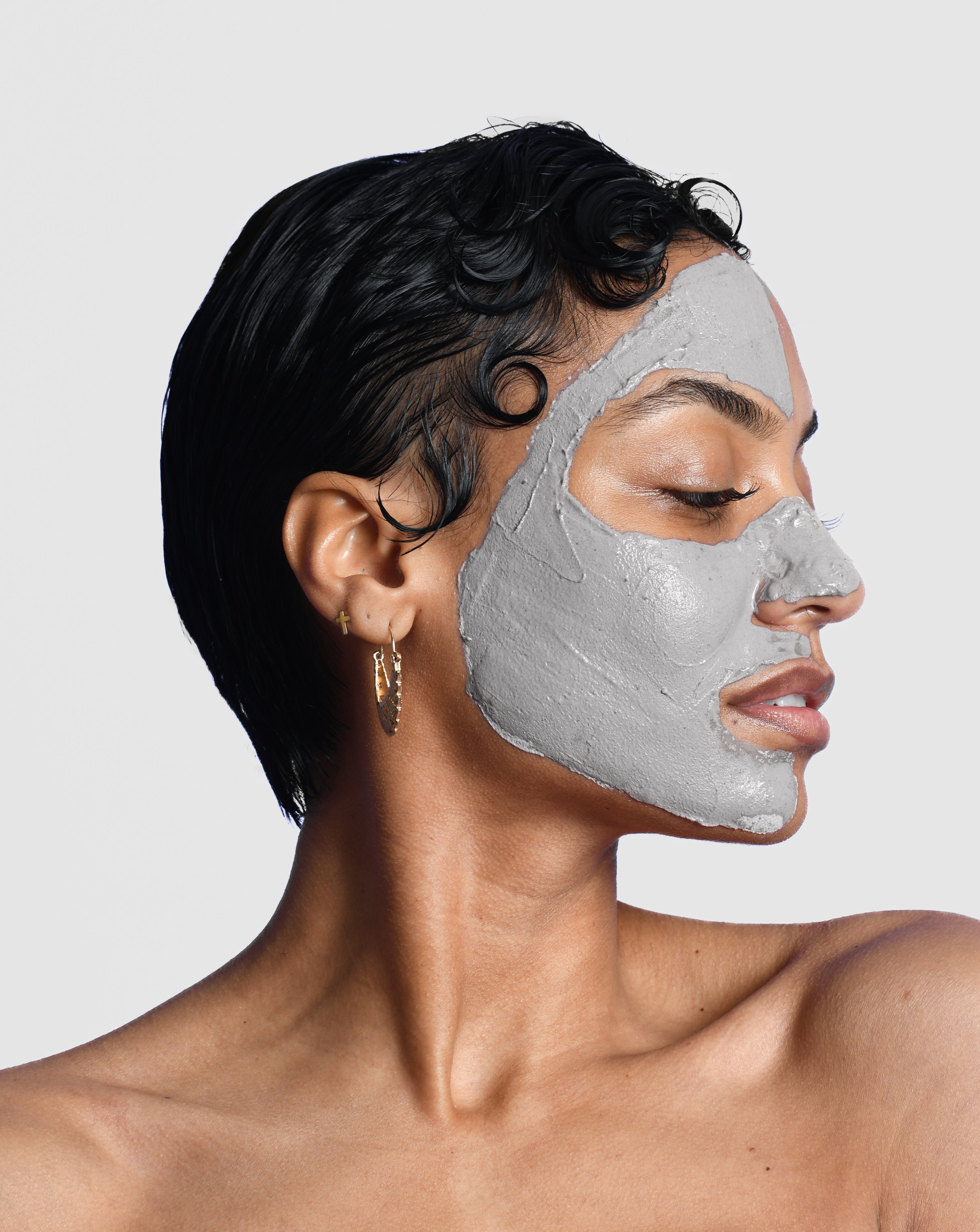 Skin care model with an activated charcoal mask facial on