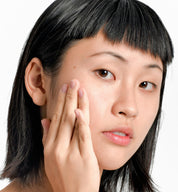 Asian Natural Skincare Model Holding her hand to her face 