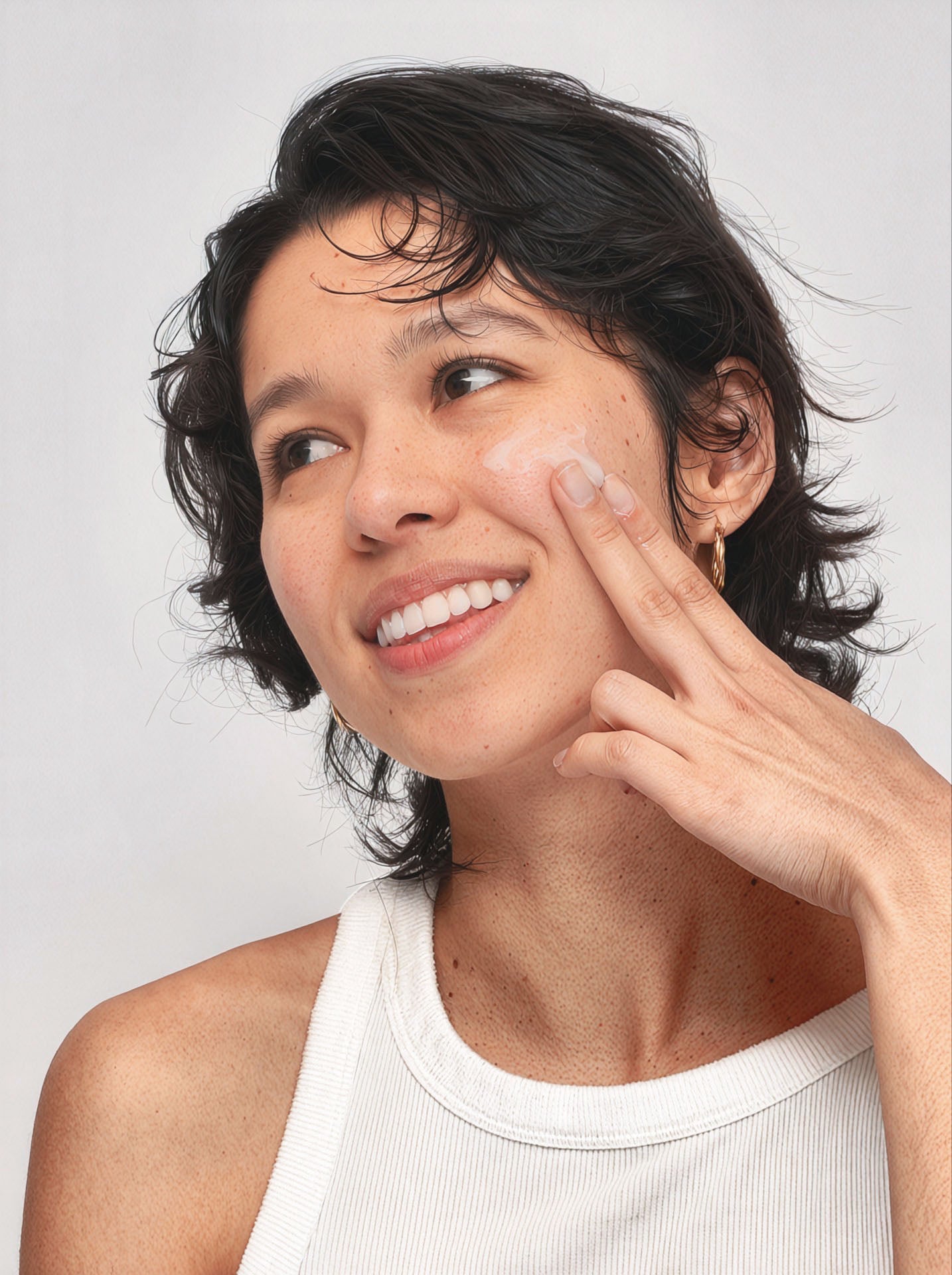 a woman applying cream on her face